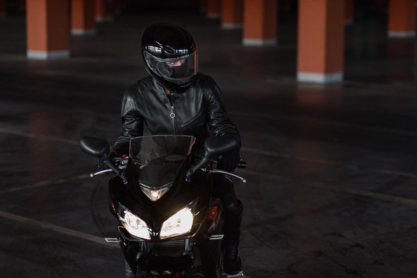 Female rider in protective biker jacket as one of the most important women motorcycle gear